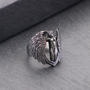 Macro shot of gothic angel wings relief on a vintage silver titanium steel ring