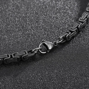 Detail of vintage black stainless steel chain link with secure lobster clasp closure
