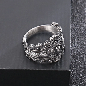Macro shot of vintage silver crown ring with cubic zirconia stones on black background