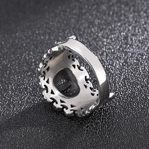 Retro crown punk style silver stainless steel ring with eye-shaped relief on black background