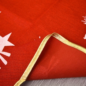 Red linen Christmas tree skirt with white stars and elegant gold metallic borders