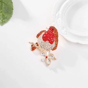 Elegant red rhinestone bird brooch on a gold floral branch with white crystal accents
