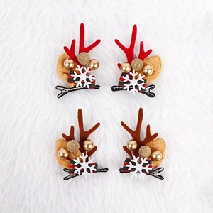 Christmas reindeer antler hair clips set with festive bells and striped bows on white fur