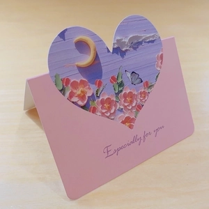 Detail of pink card with heart cutout showing floral oil painting and for you text