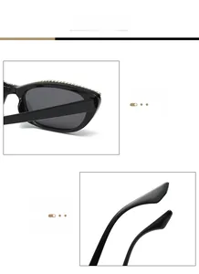 Vue détaillée des lunettes de soleil œil-de-chat noires avec strass et branches courbées
