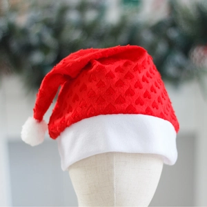 Red plush Christmas hat featuring embossed heart patterns and white trim for festive party