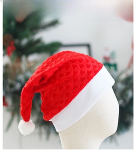 Detail of red plush Christmas hat featuring heart patterns and soft white faux fur trim