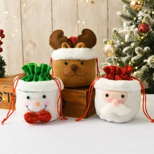 Three festive Christmas drawstring gift bags featuring Santa, Reindeer and Snowman designs