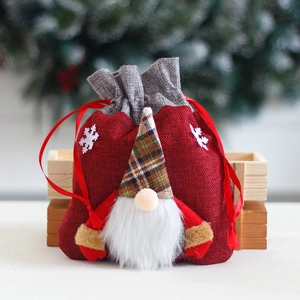 Red Christmas burlap gift bag featuring a cute forest gnome with plaid hat and drawstrings