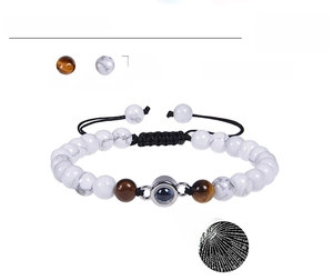 Detail of 6mm tiger eye and howlite beads with 100 languages projection stone