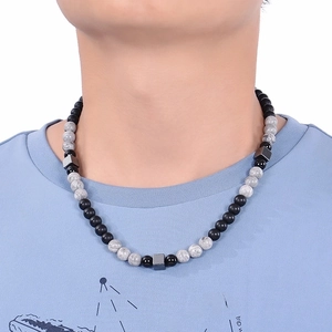 Detail of 8mm tiger eye and lava stone necklace with matte black beads and metal cubes
