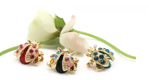 Detail of ladybug brooches with colorful rhinestones and gold-plated alloy base