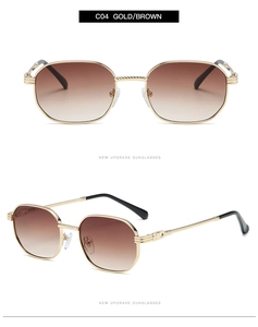 Detailed view of gold metal hexagonal sunglasses with brown gradient lenses and textured arms