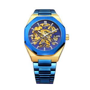 Close-up of gold hollow skeleton movement and blue bezel on a mechanical watch