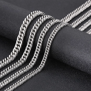Close-up of polished silver titanium steel curb chain showing heavy metal texture