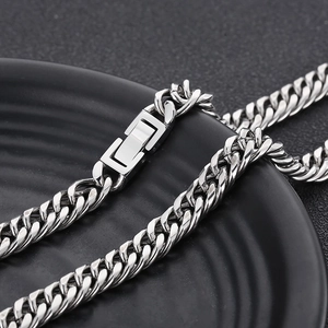 Detailed macro shot of silver stainless steel Cuban link chain with square lobster clasp