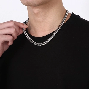 Macro shot of silver titanium steel Cuban link chain with a polished square buckle detail