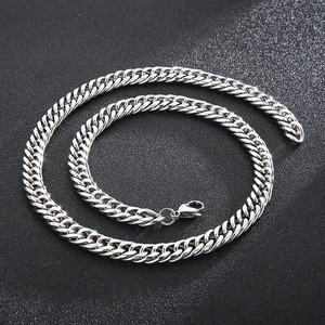 Macro detail of silver curb chain link texture with a secure lobster clasp closure
