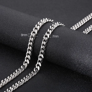 Titanium steel Cuban link chain necklace in 8mm and 7mm widths shown on a display