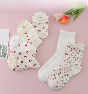 Detailed view of floral embroidery and lace edges on Japanese style cotton socks