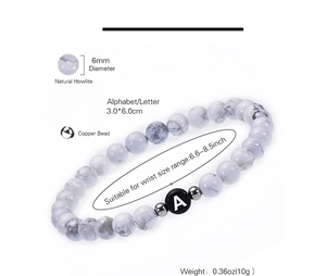 Detailed view of 6mm natural howlite beaded bracelet with letter A charm and copper beads