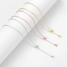 Close-up of adjustable silver, gold, and rose gold box chains with sliding bead clasp