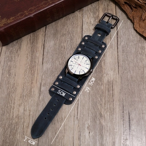 Macro view of vintage leather wristband watch showing rustic texture and metal rivets