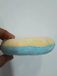 Close-up detail of yellow and sky blue soft plush fabric on a round dog toy