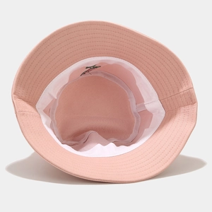 Detail of pink cotton bucket hat interior showing white sweatband and rose embroidery
