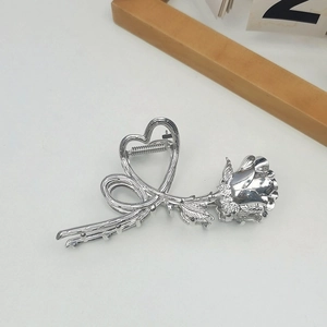 Silver metal hair claw clip featuring a detailed rose flower with a heart-shaped hinge design