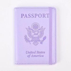 Detalle de funda para pasaporte lavanda con emblema grabado y cierre de banda elástica