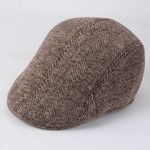 Close-up of brown herringbone tweed fabric texture on a retro British style ivy cap