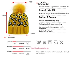 Detail showing bright yellow leopard print knit hat with large faux fur pompom dimensions