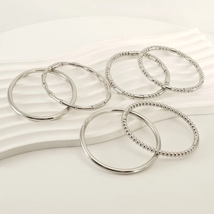 Set of six silver titanium steel bracelets featuring bamboo and beaded texture designs