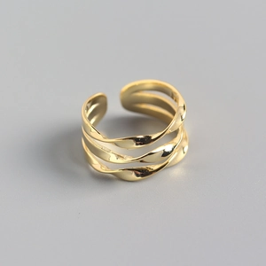 Detailed close-up of multi-layer twisted gold ring featuring a polished hollow design