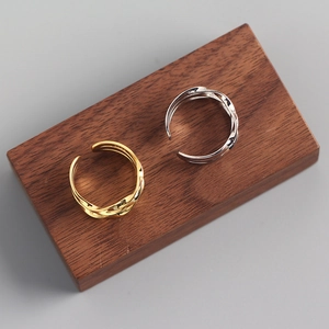 Close-up of gold and silver S925 sterling silver rings with elegant twisted texture design