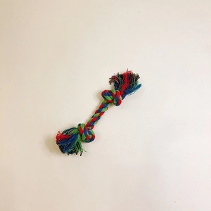 Macro shot of durable tricolor cotton dog rope toy featuring reinforced knots and fringe