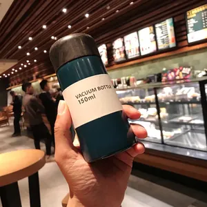 Mini 150ml dark cyan vacuum insulated water bottle held in hand showing compact pocket size