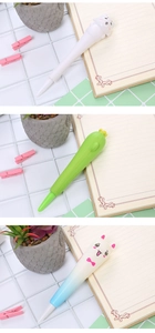 Three cute cartoon squishy stress relief pens in cat, cactus and alpaca shapes on a desk