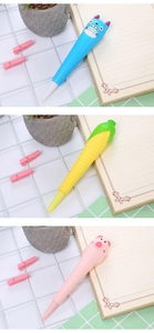 Detailed view of three cute cartoon squishy pens in blue, yellow and pink on a desk