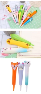 Detailed view of assorted cartoon animal and fruit squishy decompression pens on a notebook