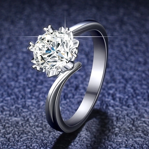 Macro view of snowflake six-prong moissanite ring with heart-shaped claw details