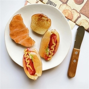 Collapsible phone grip stand set featuring realistic 3D croissant and hot dog designs