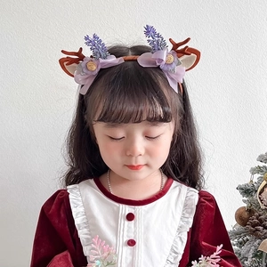 Christmas reindeer antler headband for girls with purple flowers and festive decorations