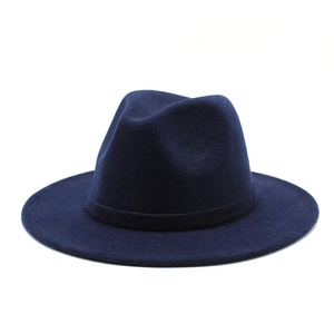 Detailed texture of navy blue wool fedora hat with wide brim and matching band ribbon