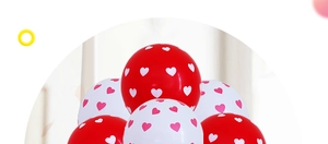 Close-up of red and white latex balloons with heart patterns for wedding decor