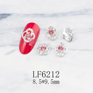 Detailed view of silver flower nail charm with pink rhinestone and size 8.5x9.5mm