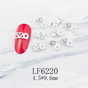 Detail of silver 520 number nail charm with grain texture and dimensions 4.5x9.6mm