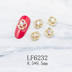Macro view of gold alloy petal nail charms with rhinestones and size measurements