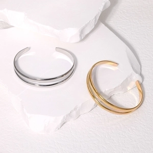 Minimalist double line open cuff bracelet in gold and silver stainless steel finish